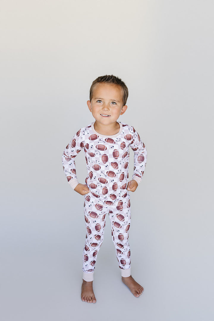 Child wearing bamboo pajamas with football pattern 