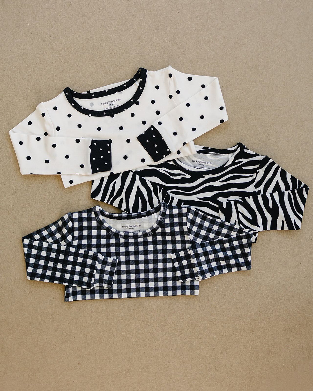 Classic Polka, Zebra, and Black Gingham Lucky Panda Kids outfits shown together