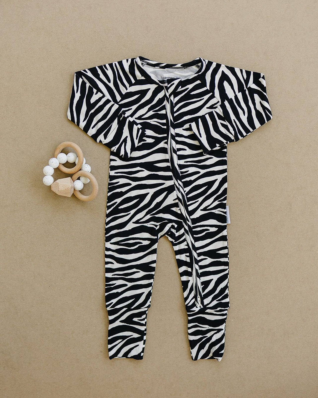 Zebra Bamboo Zip Romper flat lay showing the full one piece design