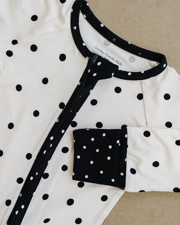 Close up of the Classic Polka Bamboo Zip Romper neckline, zipper, and pocket