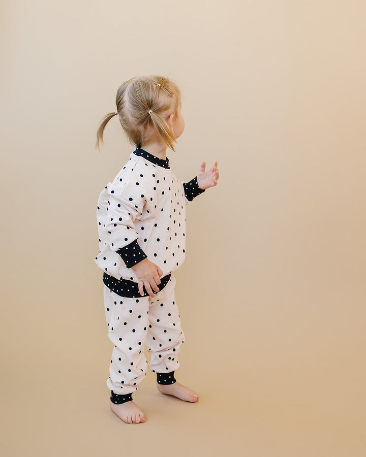 Side view of little one wearing the Classic Polka Jogger Set