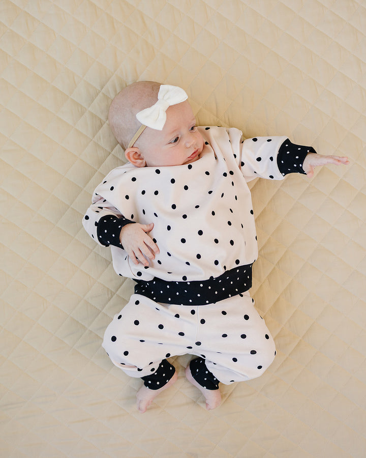Baby relaxing in the Classic Polka Jogger Set