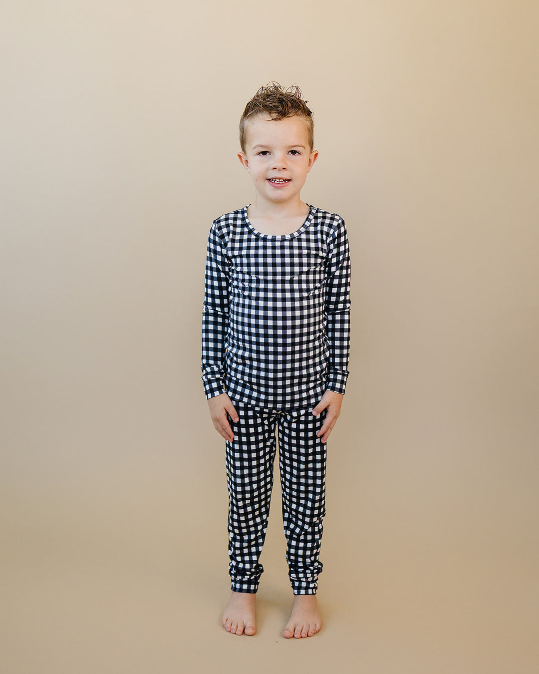 Full length view of child wearing the Black Gingham Bamboo Two Piece Set