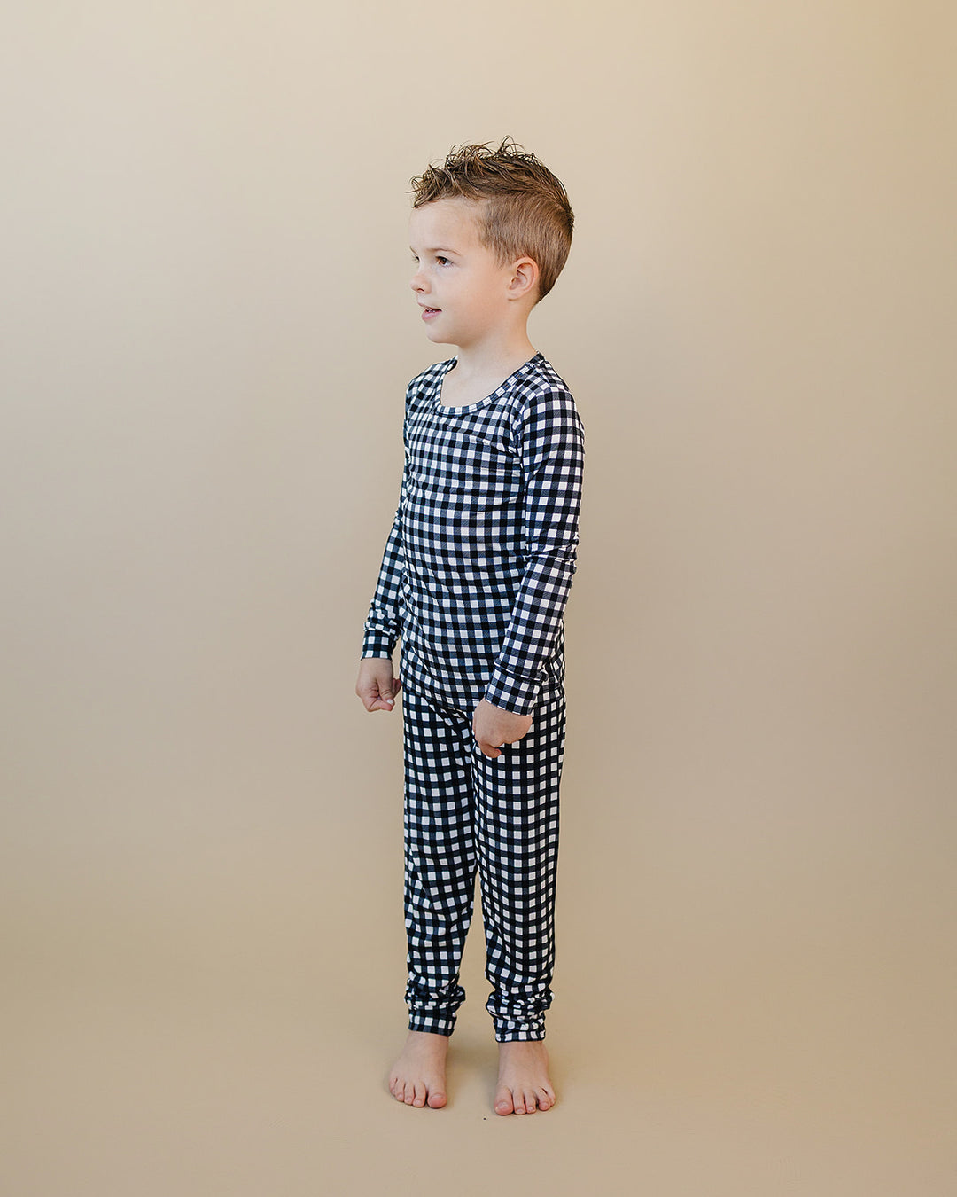 Side profile of child wearing the Black Gingham Bamboo Two Piece Set