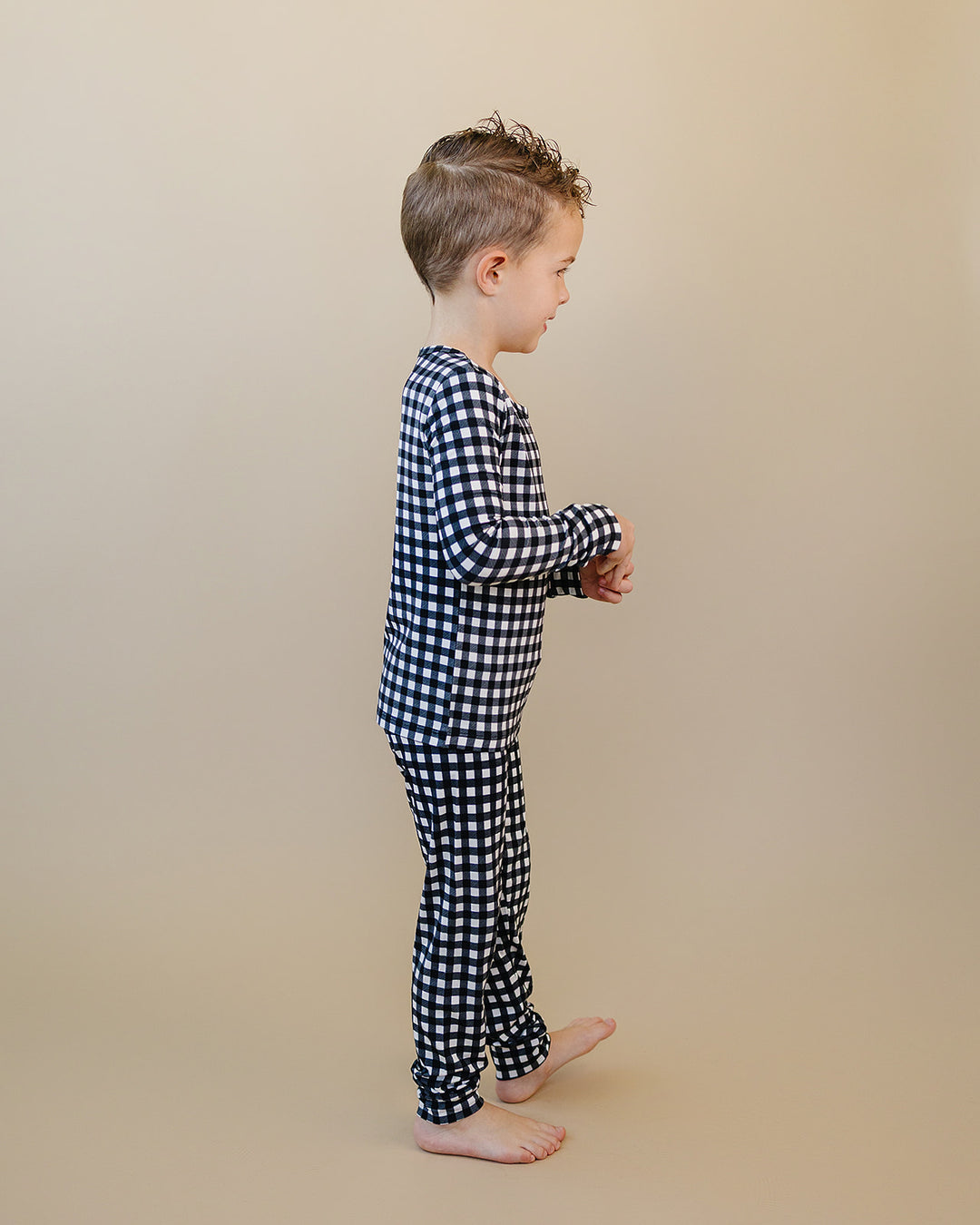 Side view of child wearing the Black Gingham Bamboo Two Piece Set