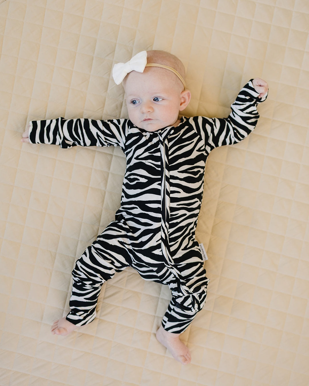 Full body view of baby wearing the Zebra Bamboo Zip Romper