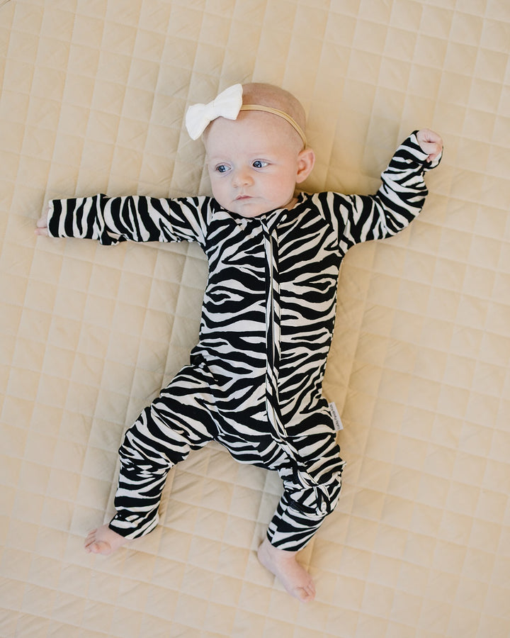 Full body view of baby wearing the Zebra Bamboo Zip Romper