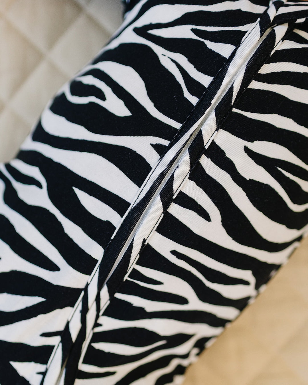Close up of the Zebra Bamboo Zip Romper showing the zipper and zebra print