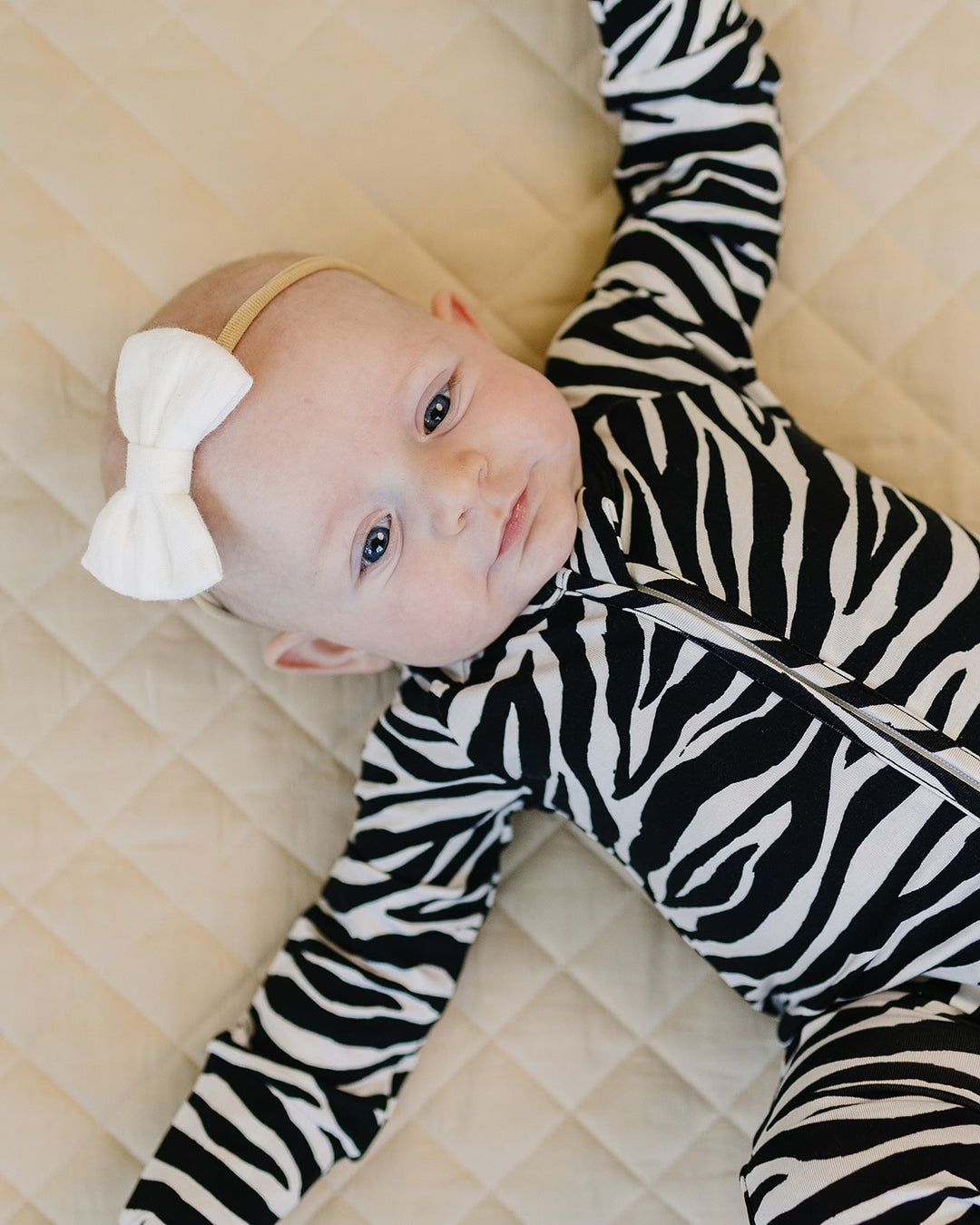 Close up of baby wearing the Zebra Bamboo Zip Romper