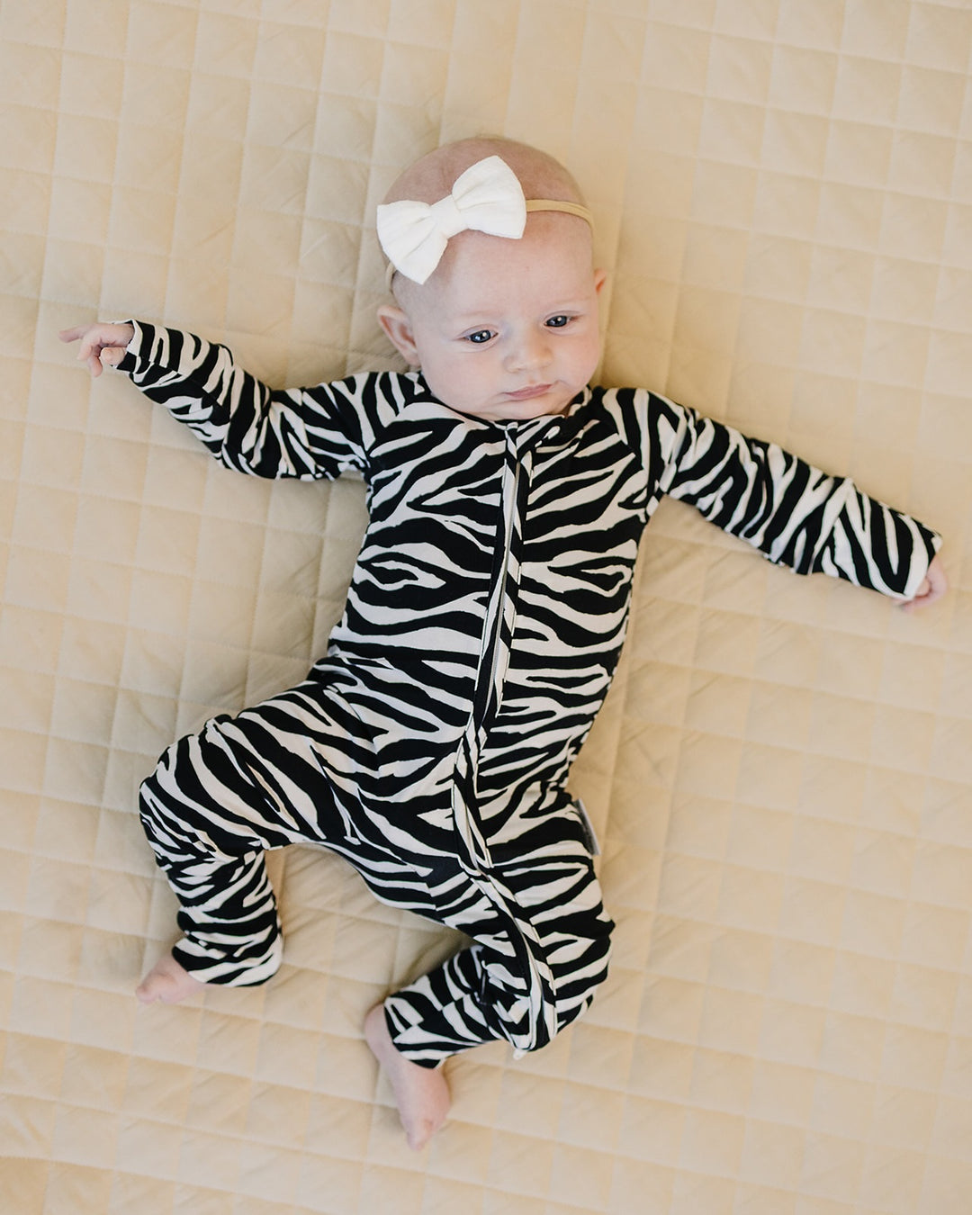Baby relaxing in the Zebra Bamboo Zip Romper