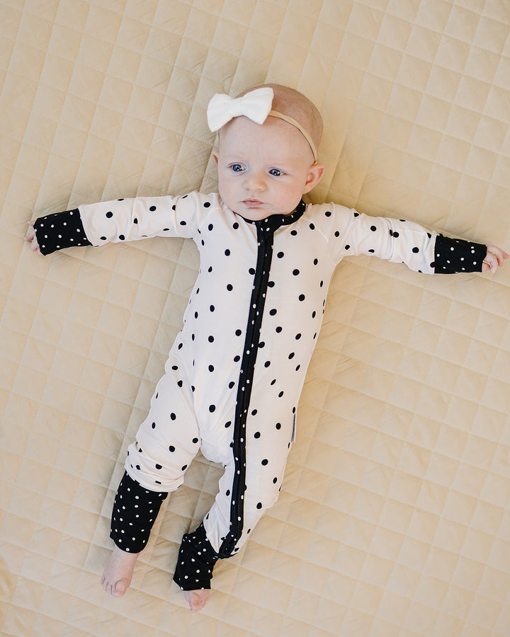 Full body view of baby wearing the Classic Polka Bamboo Zip Romper