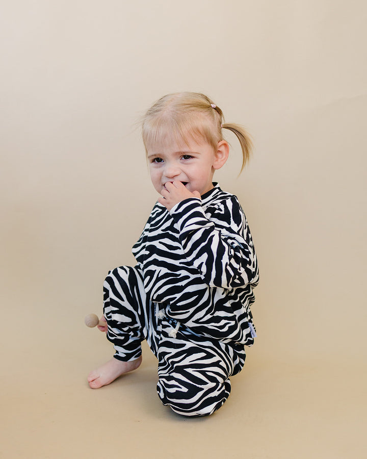 Seated little one wearing the Zebra Jogger Set