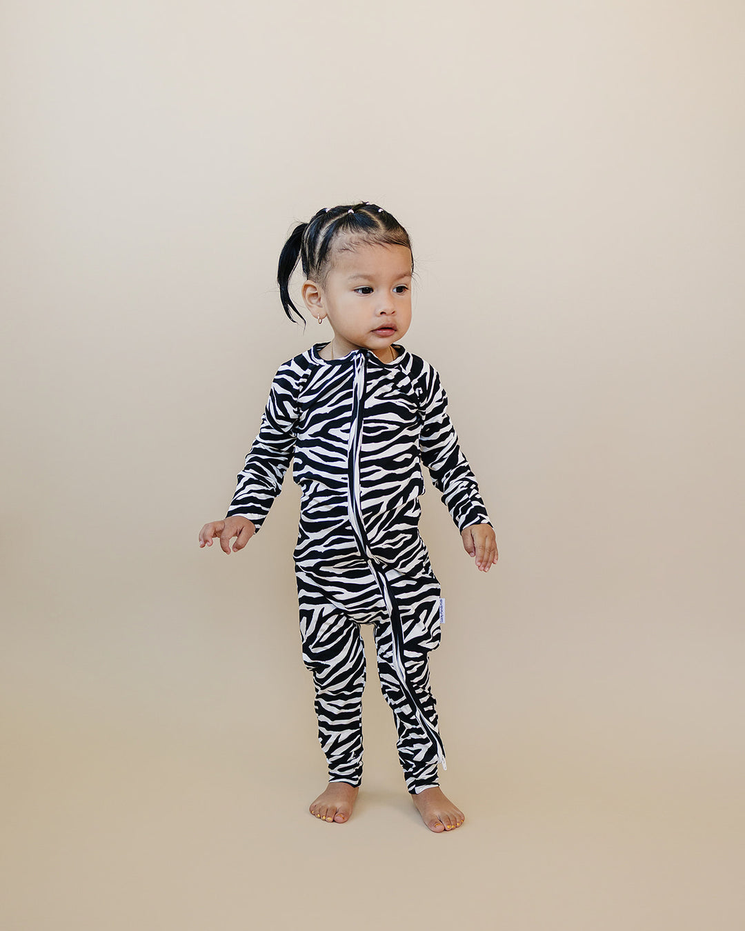 Full length view of little one wearing the Zebra Bamboo Zip Romper