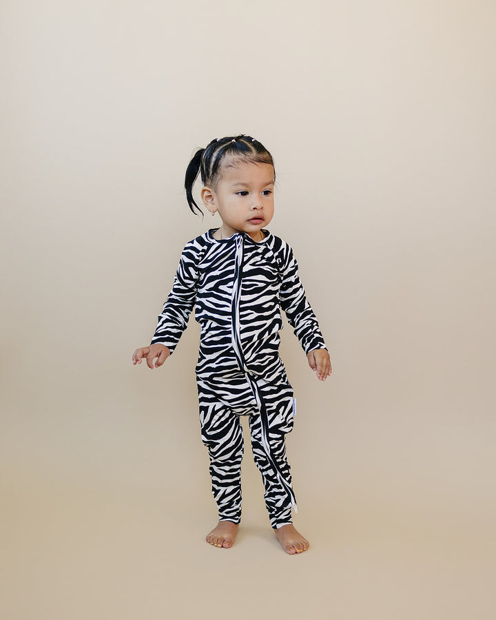 Full length view of little one wearing the Zebra Bamboo Zip Romper