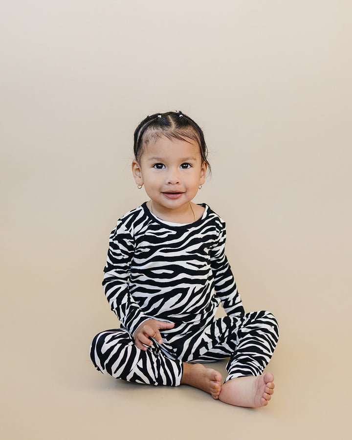 Little one sitting in the Zebra Bamboo Two Piece Set
