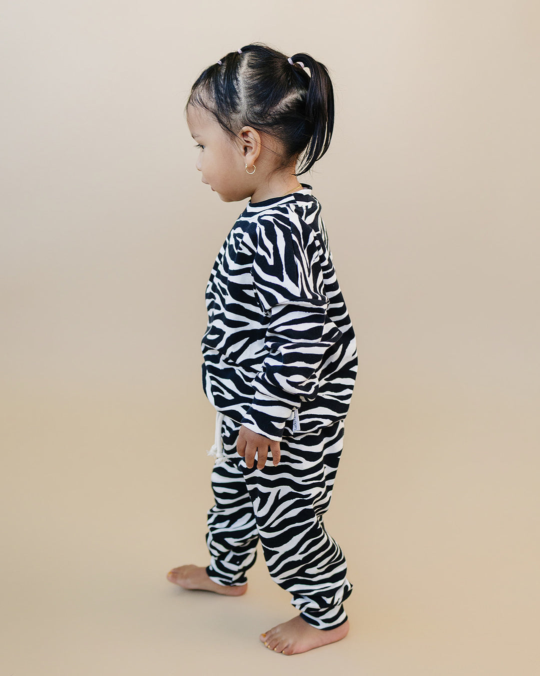 Side view of little one wearing the Zebra Jogger Set