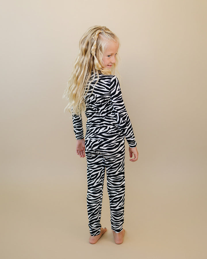 Little one modeling the Zebra Bamboo Two Piece Set in black and white zebra print