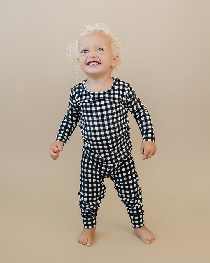 Full length lifestyle view of the Black Gingham Bamboo Two Piece Set on a little one