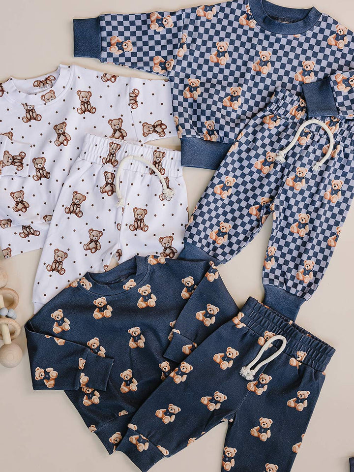 Coordinating Cute Bear, Bear Vibes, and Checkered Bear children’s outfits displayed flat.