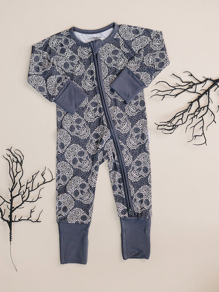 Grey Leopard Skull Halloween Bamboo Zip Romper displayed flat with dried branch decor.