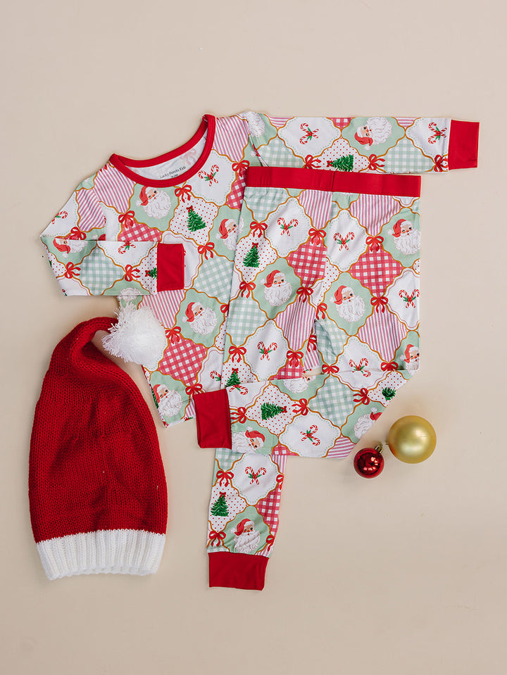 Santa Patchwork Bamboo Two Piece — toddler girl in ornament patchwork Christmas pajama set, Lucky Panda Kids, flat lay
