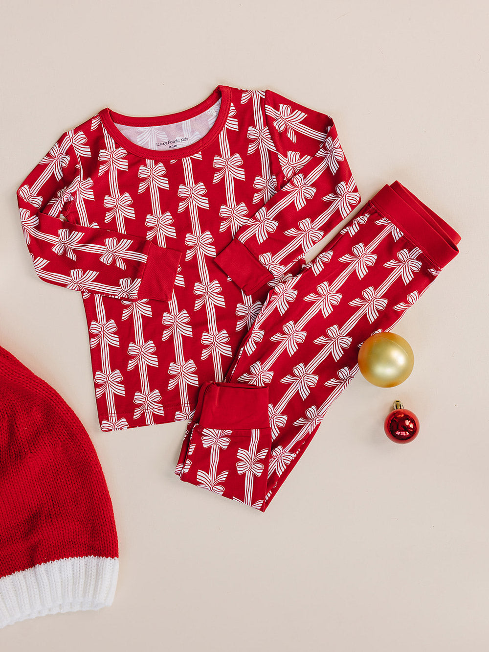  Red Bows Bamboo Two Piece —  Christmas pajama set, flat lay Lucky Panda Kids
