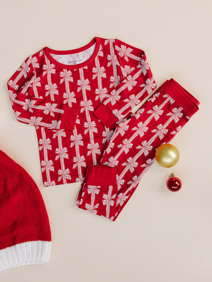  Red Bows Bamboo Two Piece —  Christmas pajama set, flat lay Lucky Panda Kids
