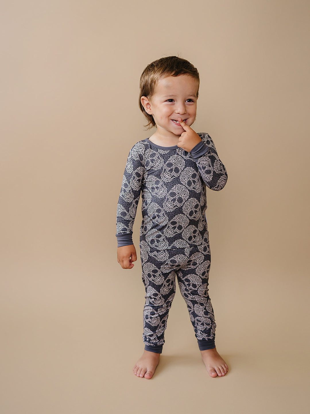 Toddler smiling in the Leopard Skull Halloween Bamboo Pajama Set.