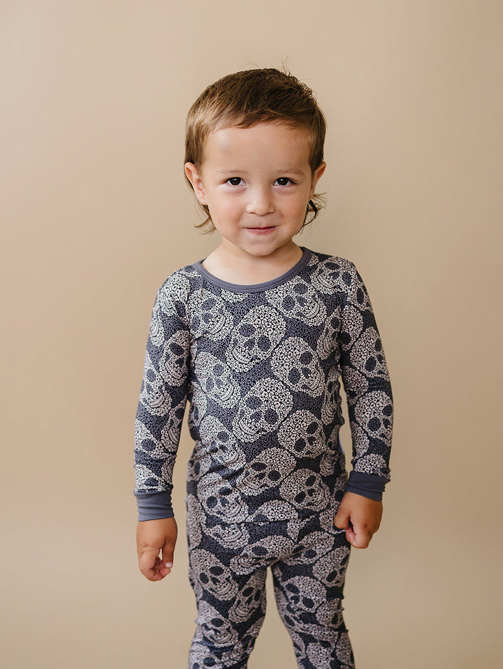 Toddler modeling the grey Leopard Skull bamboo pajama top and pants.