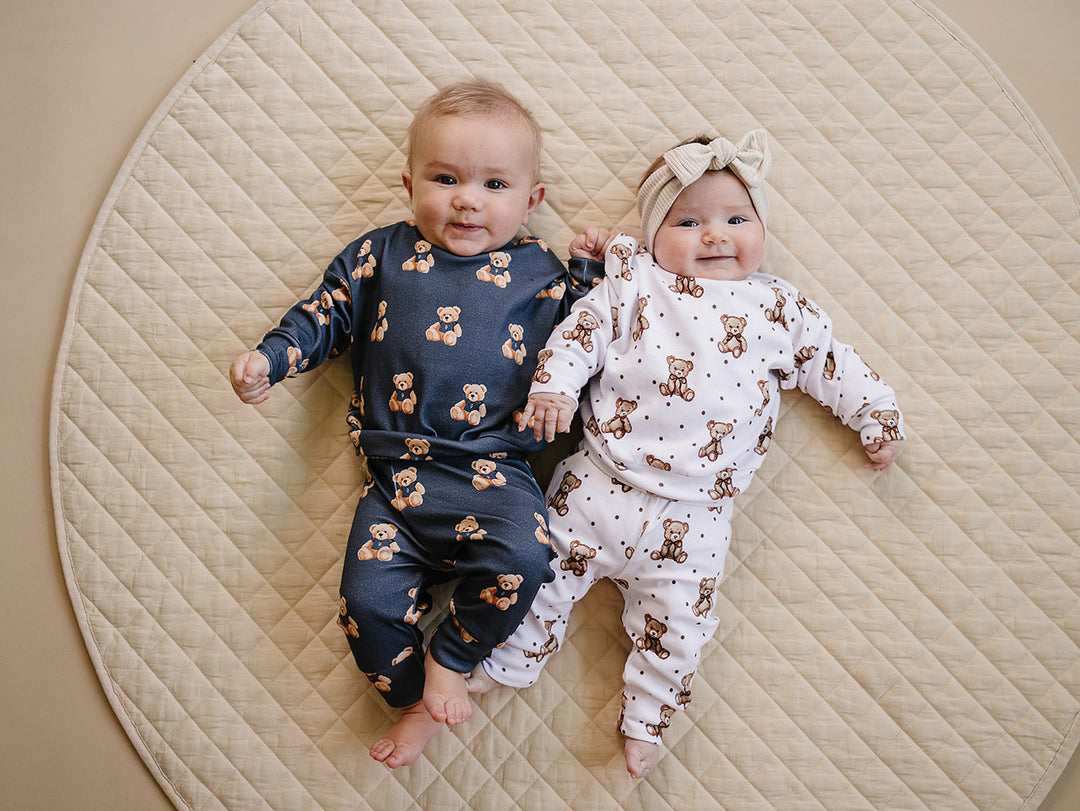 Baby wearing the Bear Vibes jogger set beside a baby in a coordinating Cute bear  outfit.