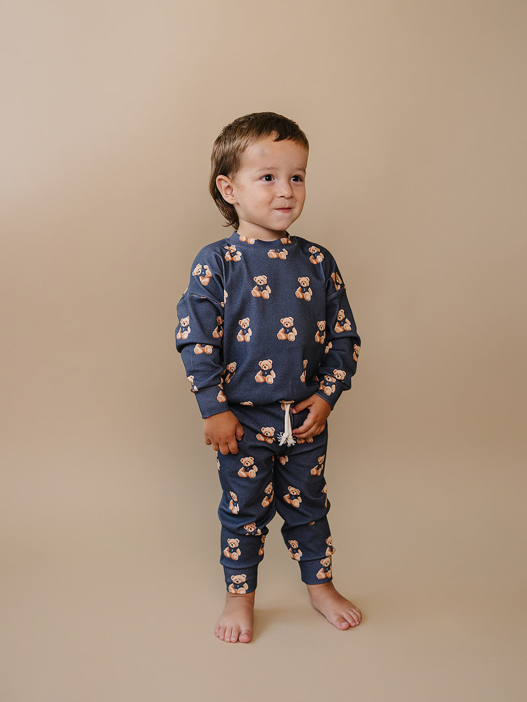 Toddler modeling the dark charcoal Bear Vibes two-piece jogger set against a neutral background.