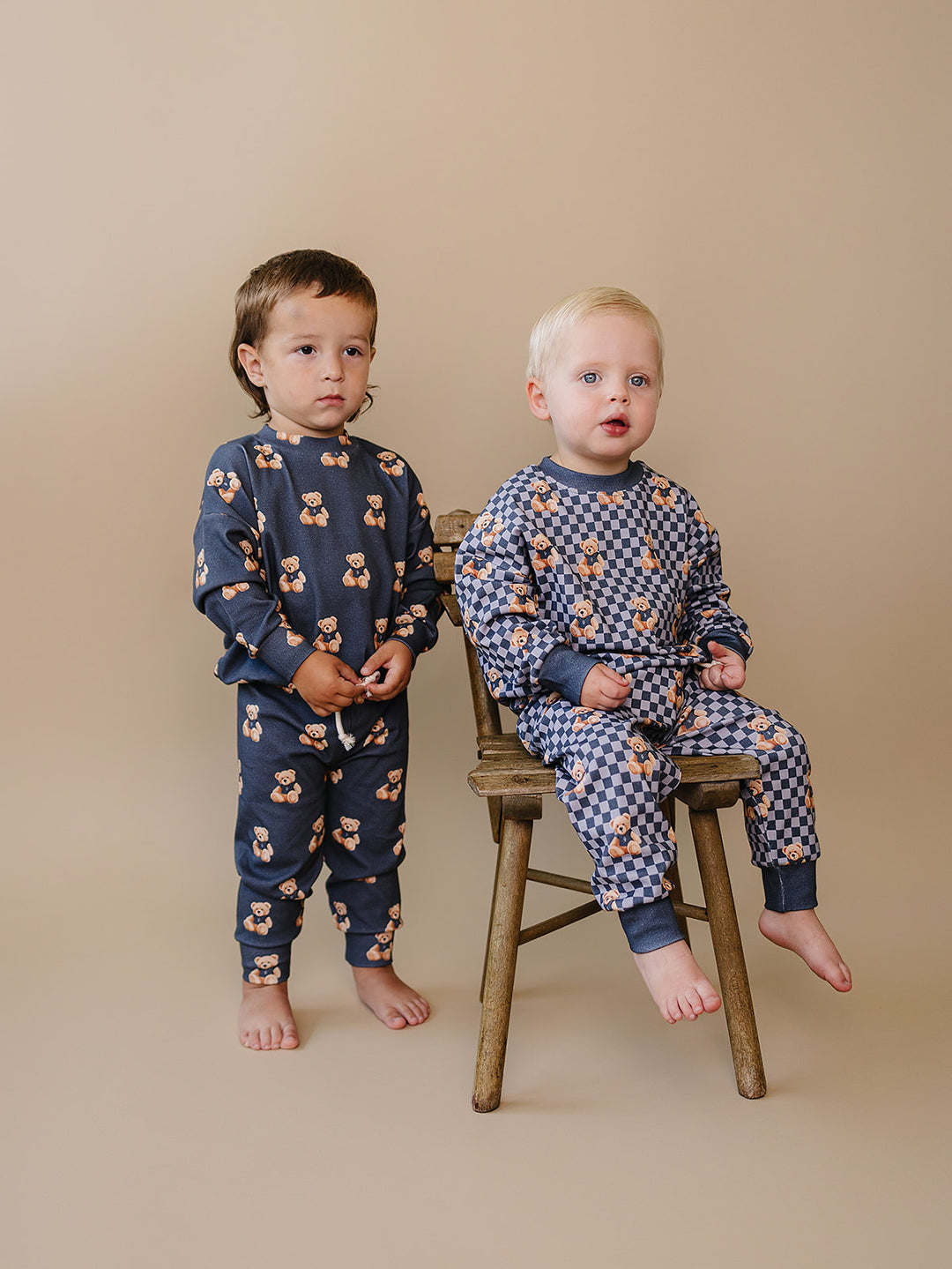 Two children wearing coordinating Bear Vibes and Checkered Bear Vibes jogger sets.