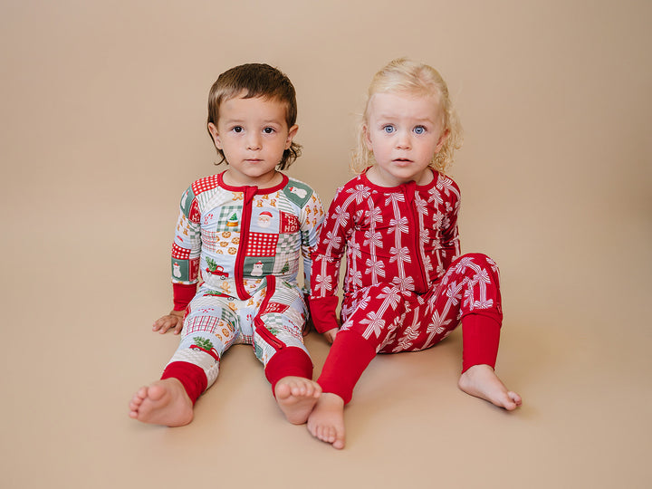 Red Bows Bamboo Zippy — baby girl in red bow-print Christmas romper, Lucky Panda Kids