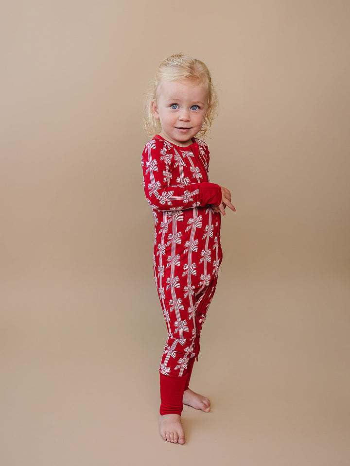 Red Bows Bamboo Zippy — baby girl in red bow-print Christmas romper, Lucky Panda Kids