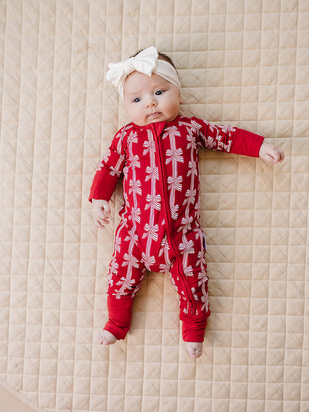 Red Bows Bamboo Zippy — baby girl in red bow-print Christmas romper, Lucky Panda Kids