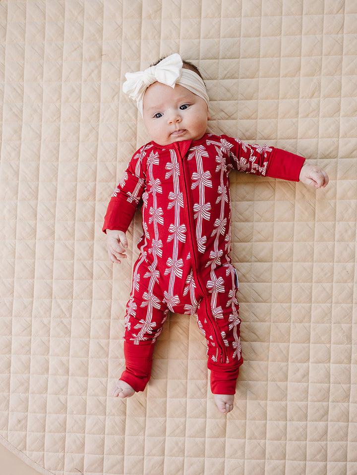 Red Bows Bamboo Zippy — baby girl in red bow-print Christmas romper, Lucky Panda Kids