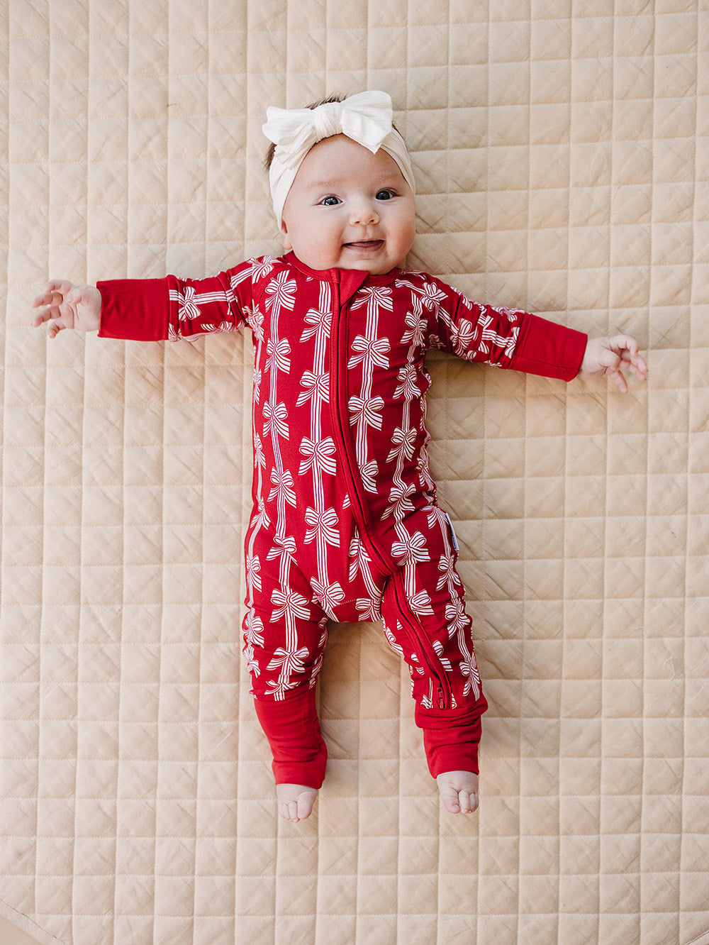 Red Bows Bamboo Zippy — baby girl in red bow-print Christmas romper, Lucky Panda Kids