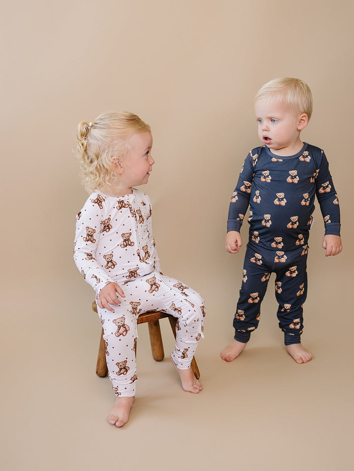 Two toddlers wearing coordinating dark charcoal and Cute Bear Vibes bamboo outfits.