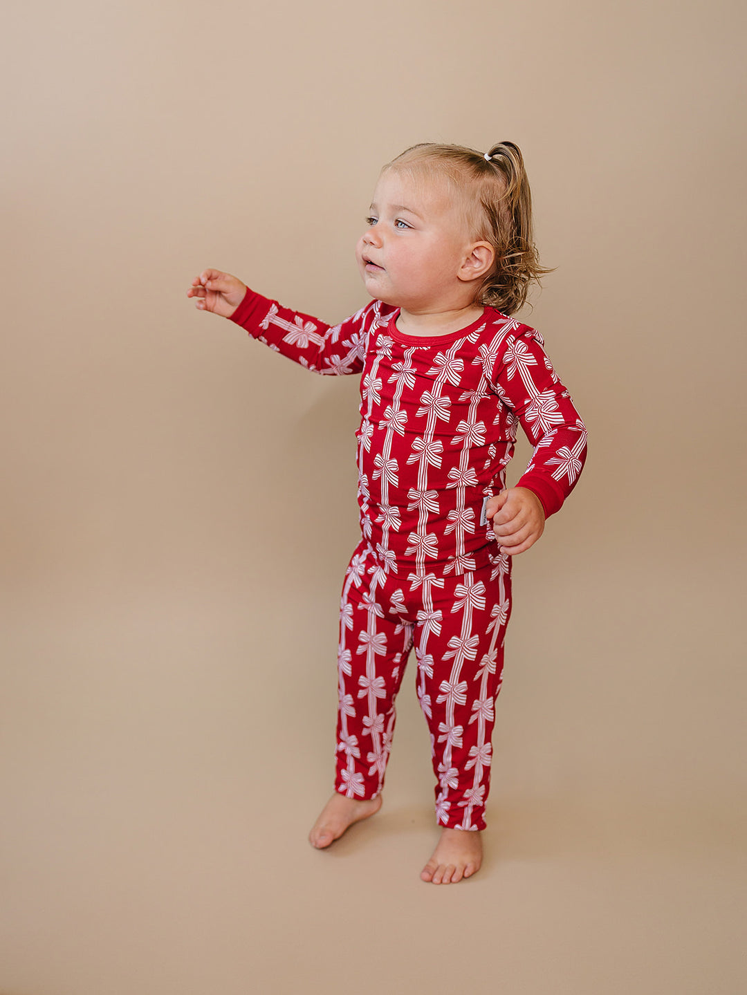  Red Bows Bamboo Two Piece — toddler girl in red bow-print Christmas pajama set, Lucky Panda Kids
