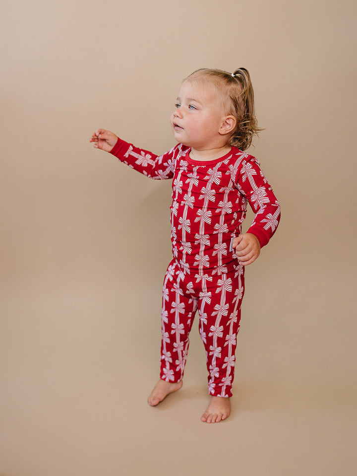  Red Bows Bamboo Two Piece — toddler girl in red bow-print Christmas pajama set, Lucky Panda Kids
