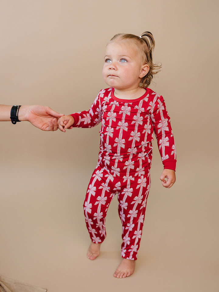 Red Bows Bamboo Two Piece — toddler girl in red bow-print Christmas pajama set, Lucky Panda Kids
