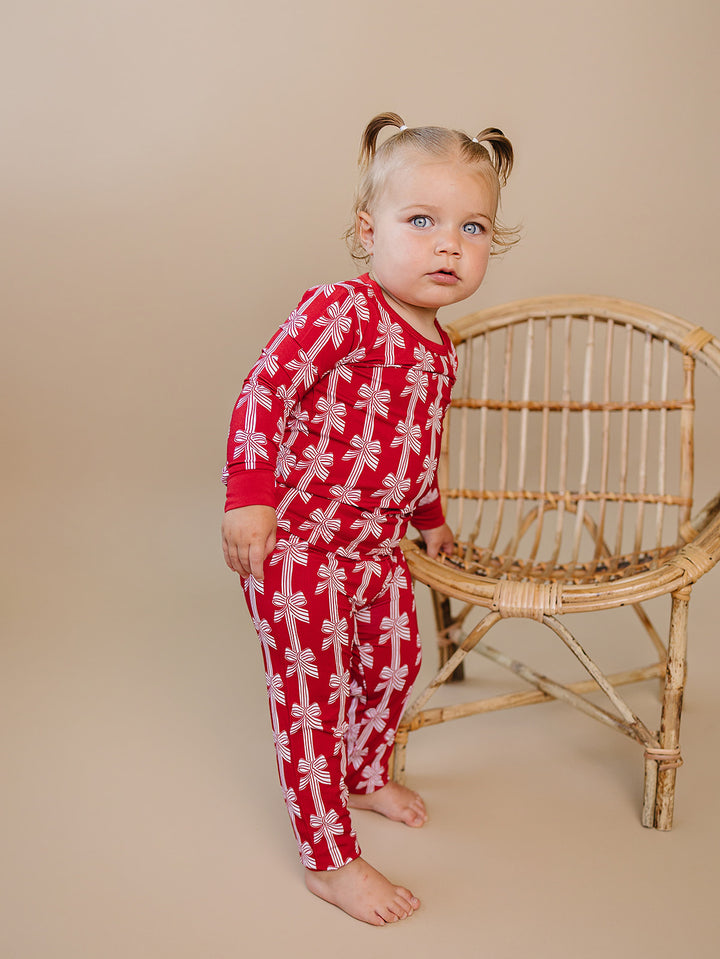  Red Bows Bamboo Two Piece — toddler girl in red bow-print Christmas pajama set, Lucky Panda Kids
