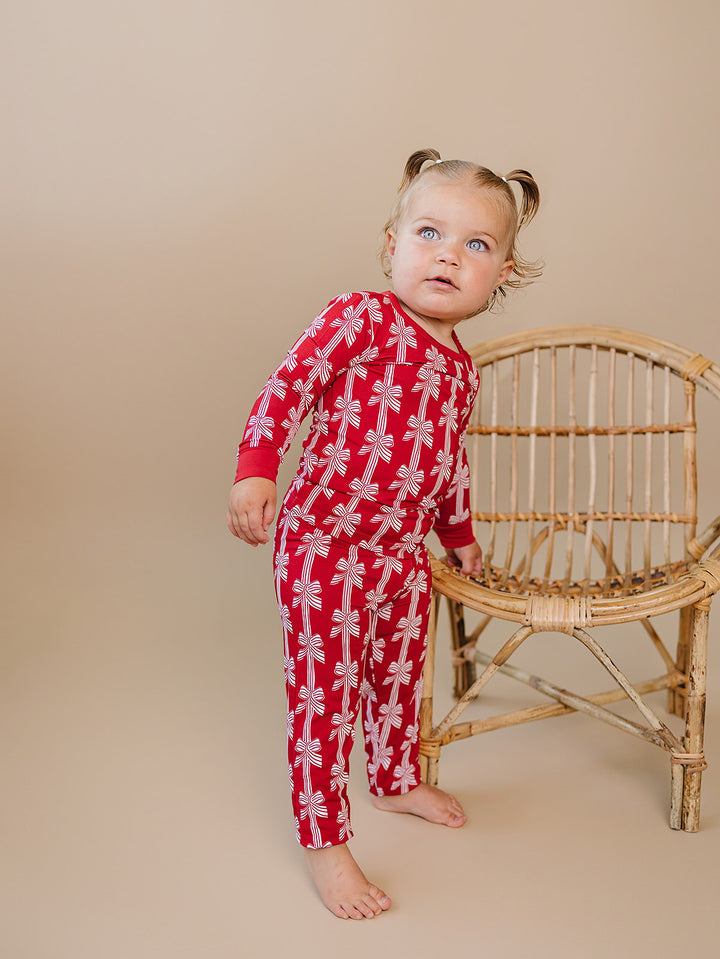 Red Bows Bamboo Two Piece — toddler girl in red bow-print Christmas pajama set, Lucky Panda Kids
