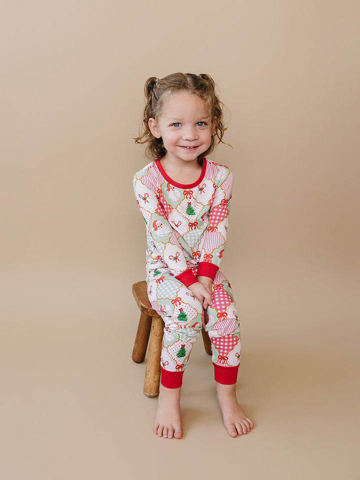 Santa Patchwork Bamboo Two Piece — toddler girl in ornament patchwork Christmas pajama set, Lucky Panda Kids
