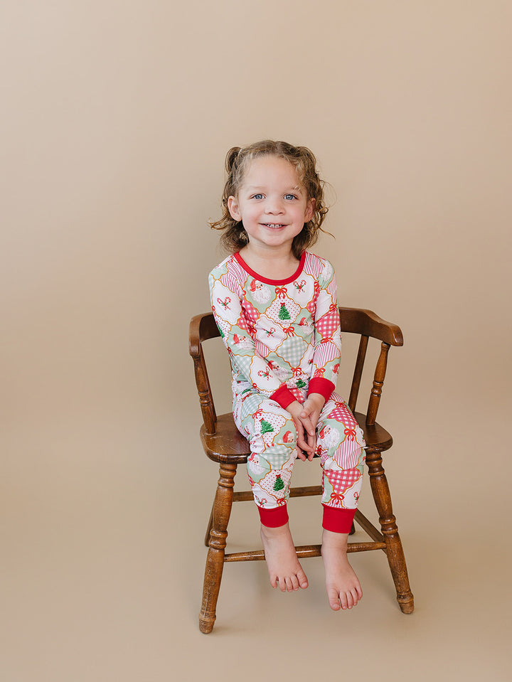 Santa Patchwork Bamboo Two Piece — toddler girl in ornament patchwork Christmas pajama set, Lucky Panda Kids
