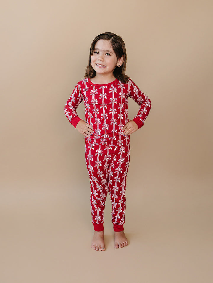  Red Bows Bamboo Two Piece — toddler girl in red bow-print Christmas pajama set, Lucky Panda Kids
