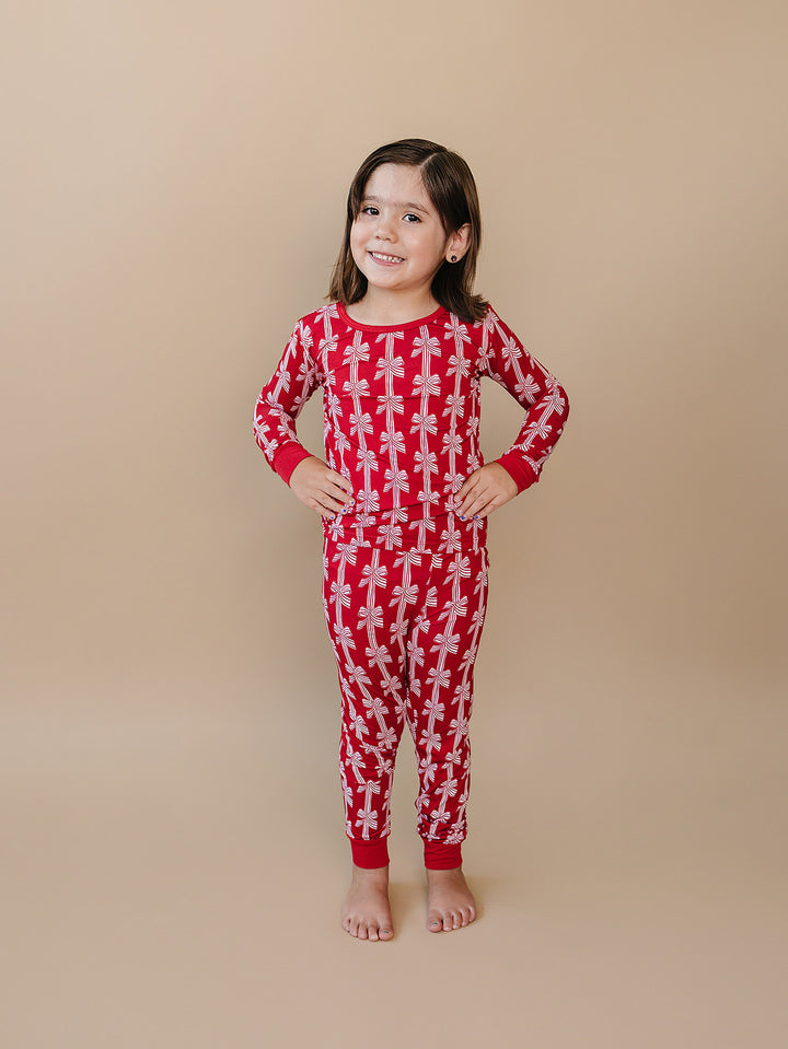  Red Bows Bamboo Two Piece — toddler girl in red bow-print Christmas pajama set, Lucky Panda Kids
