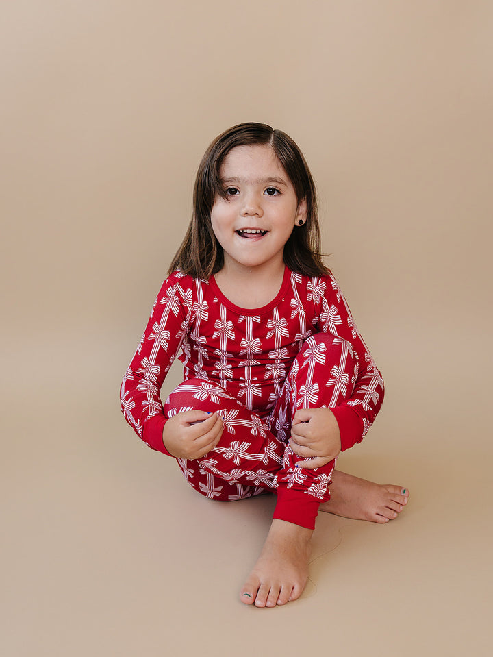  Red Bows Bamboo Two Piece — toddler girl in red bow-print Christmas pajama set, Lucky Panda Kids
