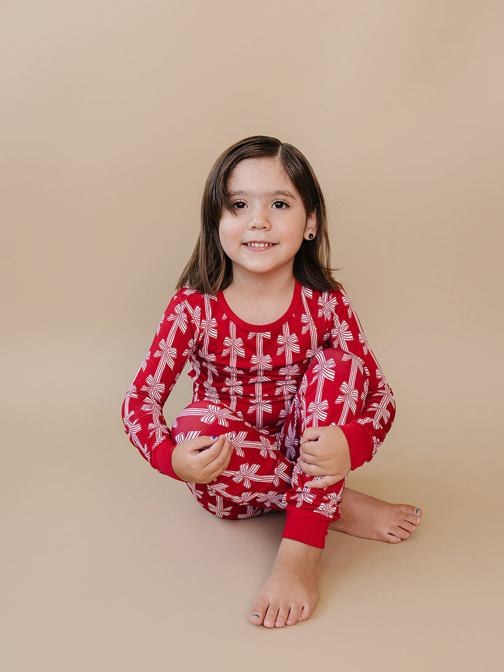 Red Bows Bamboo Two Piece — toddler girl in red bow-print Christmas pajama set, Lucky Panda Kids
