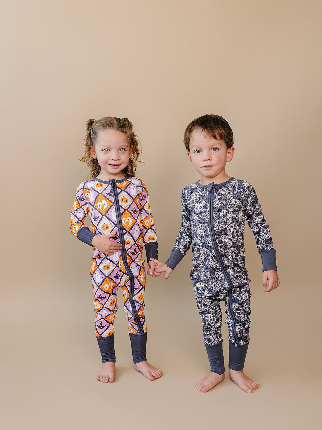 Toddler girl and boy wearing coordinating Lucky Panda Kids Halloween pajamas.